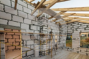 House interior under construction and renovation. Energy saving walls of hollow foam insulation blocks and bricks, ceiling beams