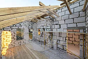 House interior under construction and renovation. Energy saving walls of hollow foam insulation blocks and bricks, ceiling beams