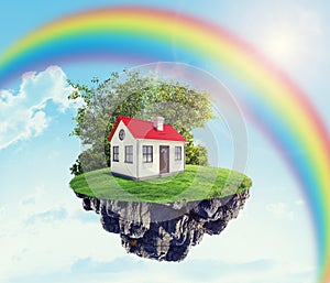 House on island with rainbow