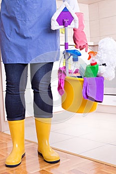 House keeper with cleaning equipment in bucket