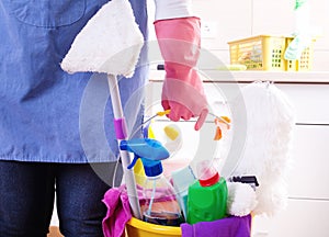 House keeper with cleaning equipment in bucket