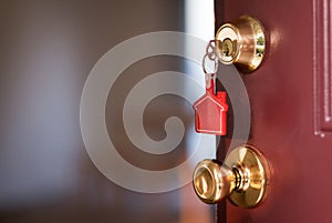 House key in the door opening into apartment