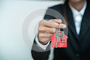 House key in hand, Female hand holding house key, real estate agent