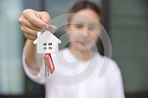 House key in hand, Female hand holding house key, real estate agent