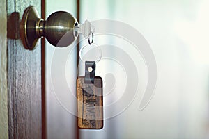 House key with home keyring in keyhole, property concept