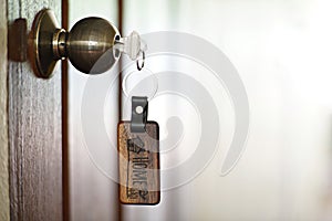 House key with home keyring in keyhole, property concept