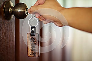 House key with home keyring in keyhole, property concept