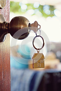 House key with home keyring in keyhole, property concept