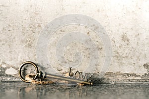 House key with home keyring in on old wood background