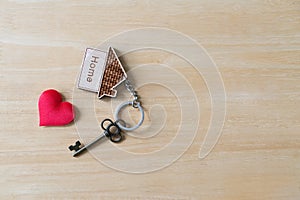 House key with home keyring on rusty wood background