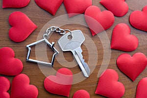 House key with home keyring on rusty wood background