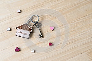 House key with home keyring on rusty wood background