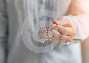 House key in landlord, real estate sale person or home Insurance broker agent hand giving to tenant, renter