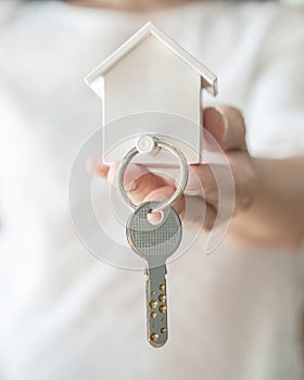 House key in landlord, real estate sale person or home Insurance broker agent hand giving to tenant, renter, buyer customer