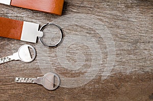 House key with Leather key chain on wooden background