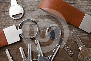 House key with leather key chain on wooden background