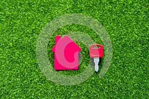 House, keys on a background of green artificial grass.