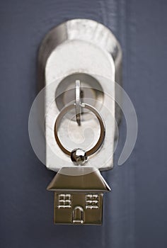 House keys in a grey door