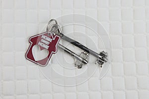 House keys with red house key chain on white background