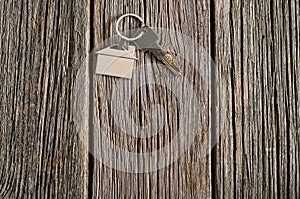 House keys symbol on old wooden floor background.