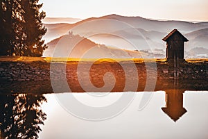 House by the lake in wonderful sunrise light. Banska Stiavnica, Slovakia