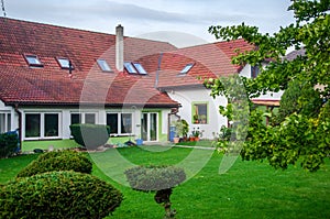 House and lawn with trees and green lawns