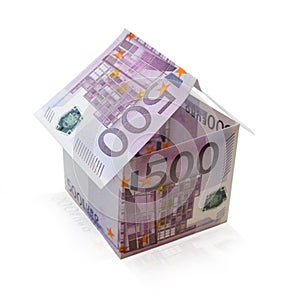 House made of banknotes on an isolated white background