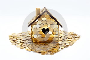 House made of coins on white background. Mortgage, savings for home purchase, utility bills, building leases and real