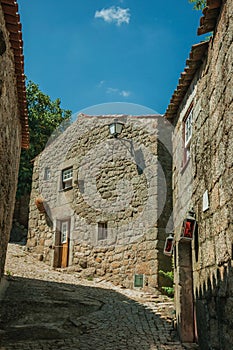 House made of stone with wooden door and deserted alley