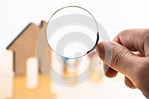 House and magnifying glass for search and explore real estate.