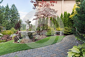 House Manicured Frontyard with Water Fountain photo
