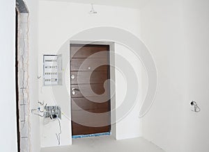 House metal entrance door with mounted open electric meter box with residual current device or RCD