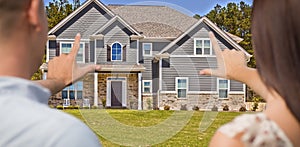 House and Military Couple Framing Hands in Front