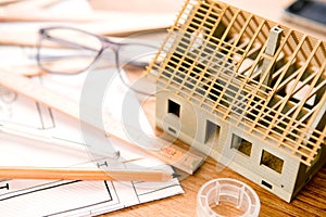 House miniature under construction on an architect desk