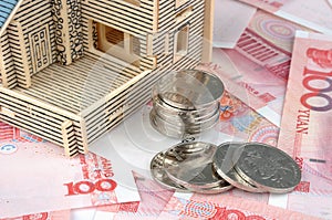 House model with banknote and coins