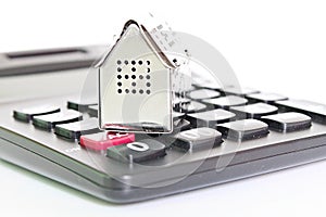 House model and calculator on office desk table