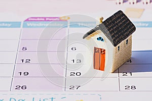 House model on calendar. planning savings money of coins to buy a home concept.