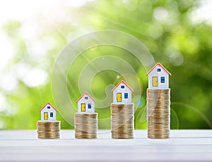 House model and coin money,mortgage and real estate investment.