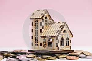 house model coins front pink background. High quality photo