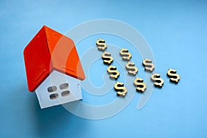 House model and dollar signs. Reverse mortgage concept. photo