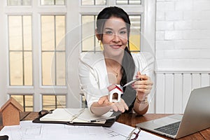 A house model on hand of Female real estate agent.
