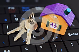 House model and keys on black keyboard