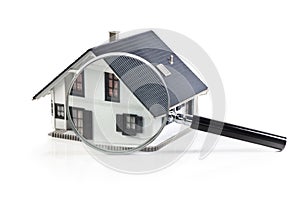 House model with magnifying glass home inspection or searching for a house