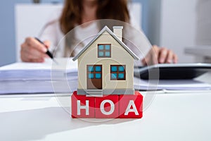 House Model Over HOA Blocks Over Desk In Office