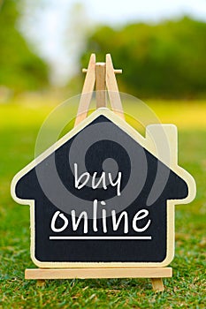 House model on stand with buy online text on it.