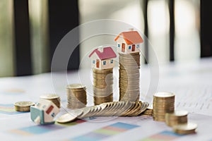 House model on top of stack of money as growth of mortgage credit, Concept of property management. Invesment and Risk Management.