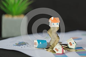 House model on top of stack of money as growth of mortgage credit, Concept of property management. Invesment and Risk Management.