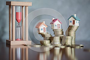 House model on top of stack of money as growth of mortgage credit, Concept of property management. Invesment and Risk Management