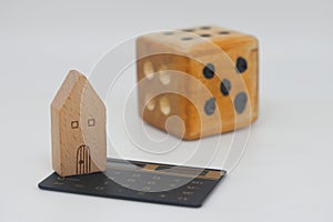 House model and wooden bones on a white background. Real estate investment concept, mortgage and risks. Illustrating