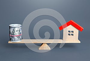 House and money balance on the scales. Buying and selling, fair price. Building maintenance. Property real estate valuation